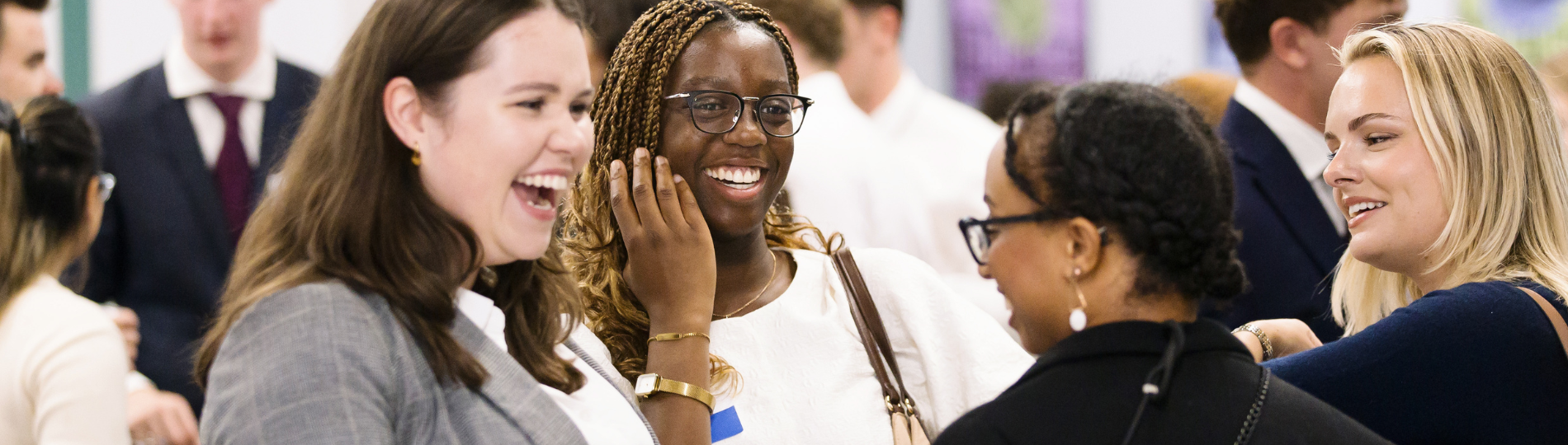 UCD Alumni engage in a conversation in an event.
